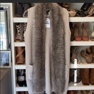 Beige faux fur vest.